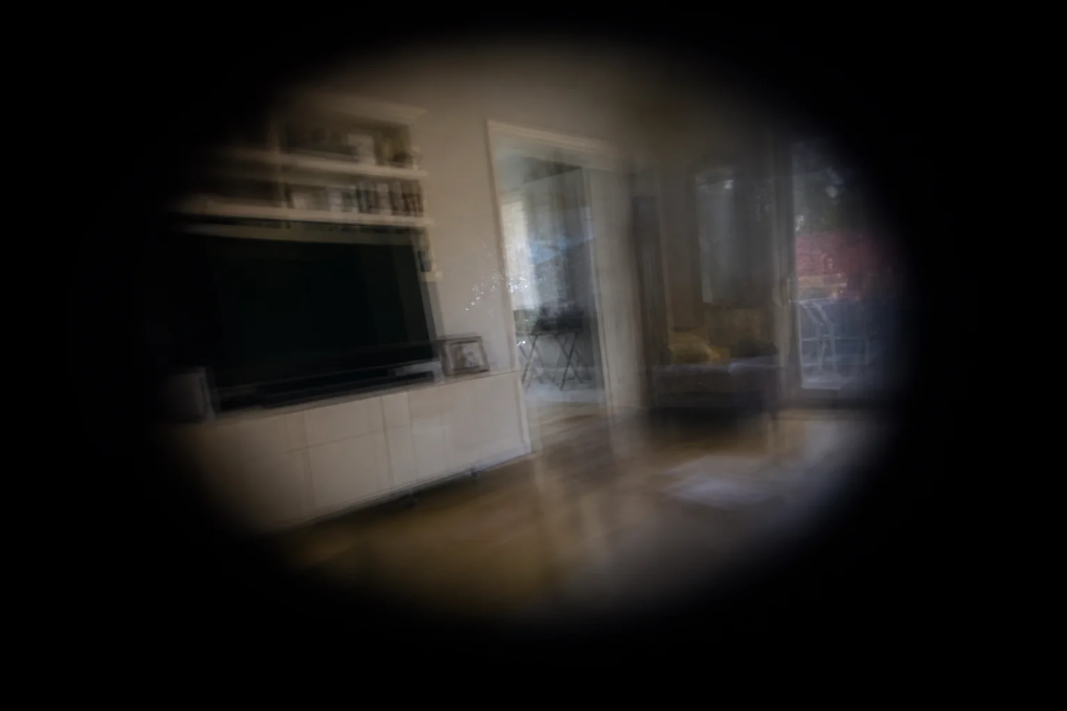 An eye-level view of a familiar indoor room is distorted by stroke-related tunnel vision, darkness, double images, warped geometry, shimmering blind spots, muted colors, and motion blur.